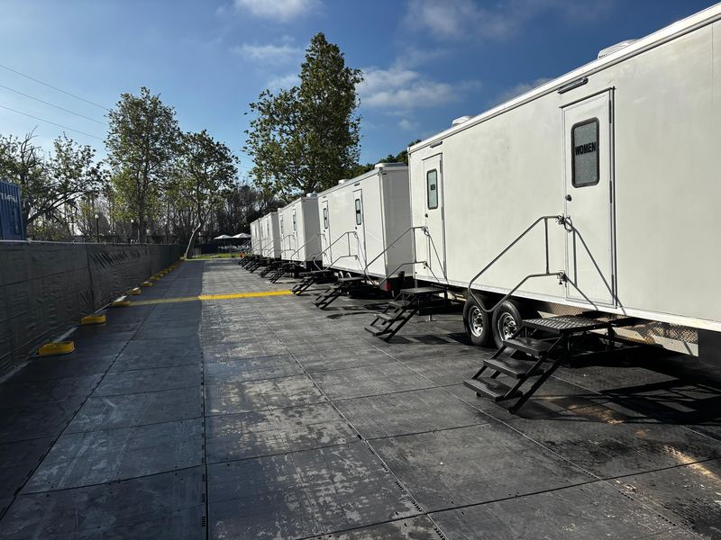 Row of restroom trailers lined up for a large festival